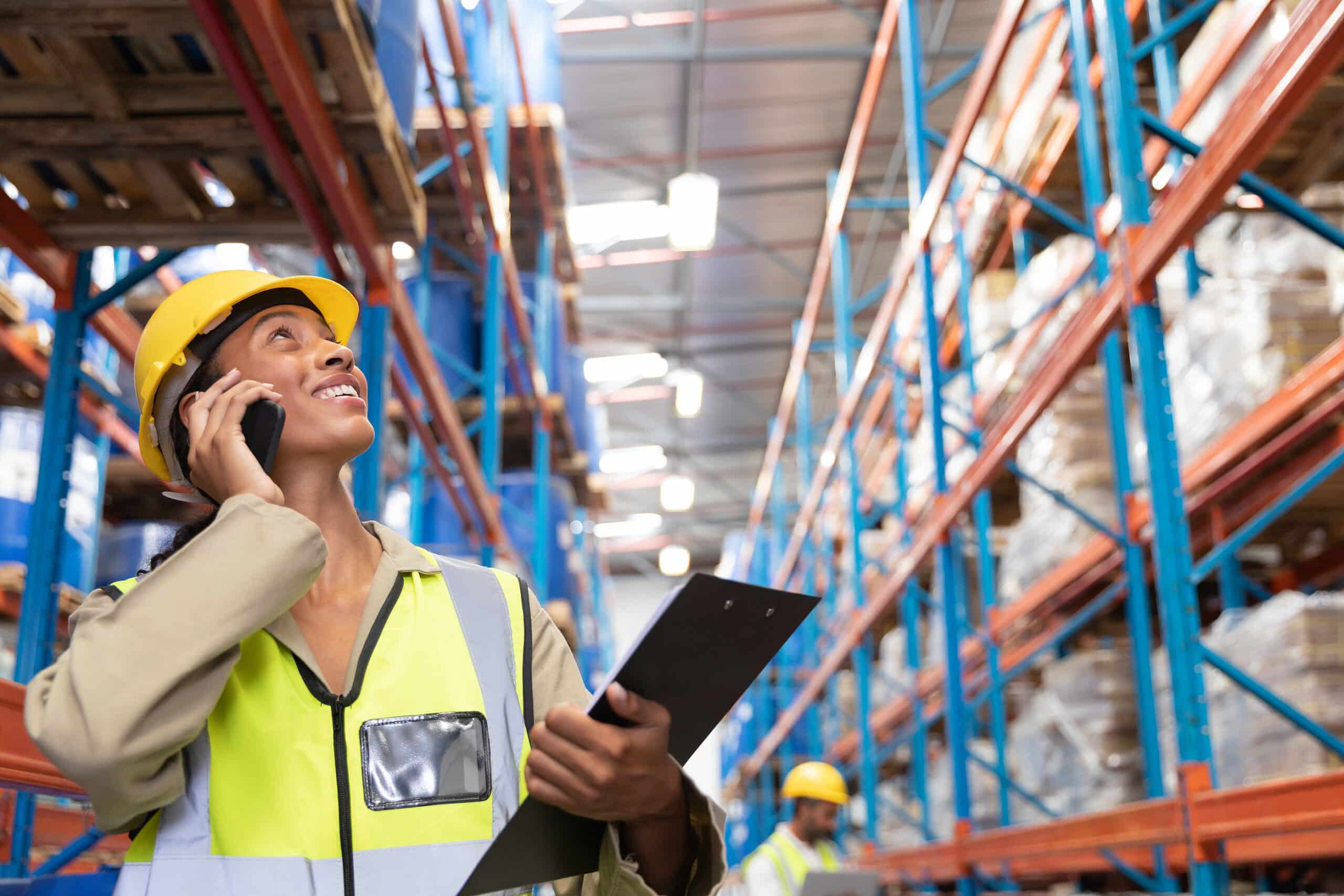 Front view of female worker looking up while talking on mobile p