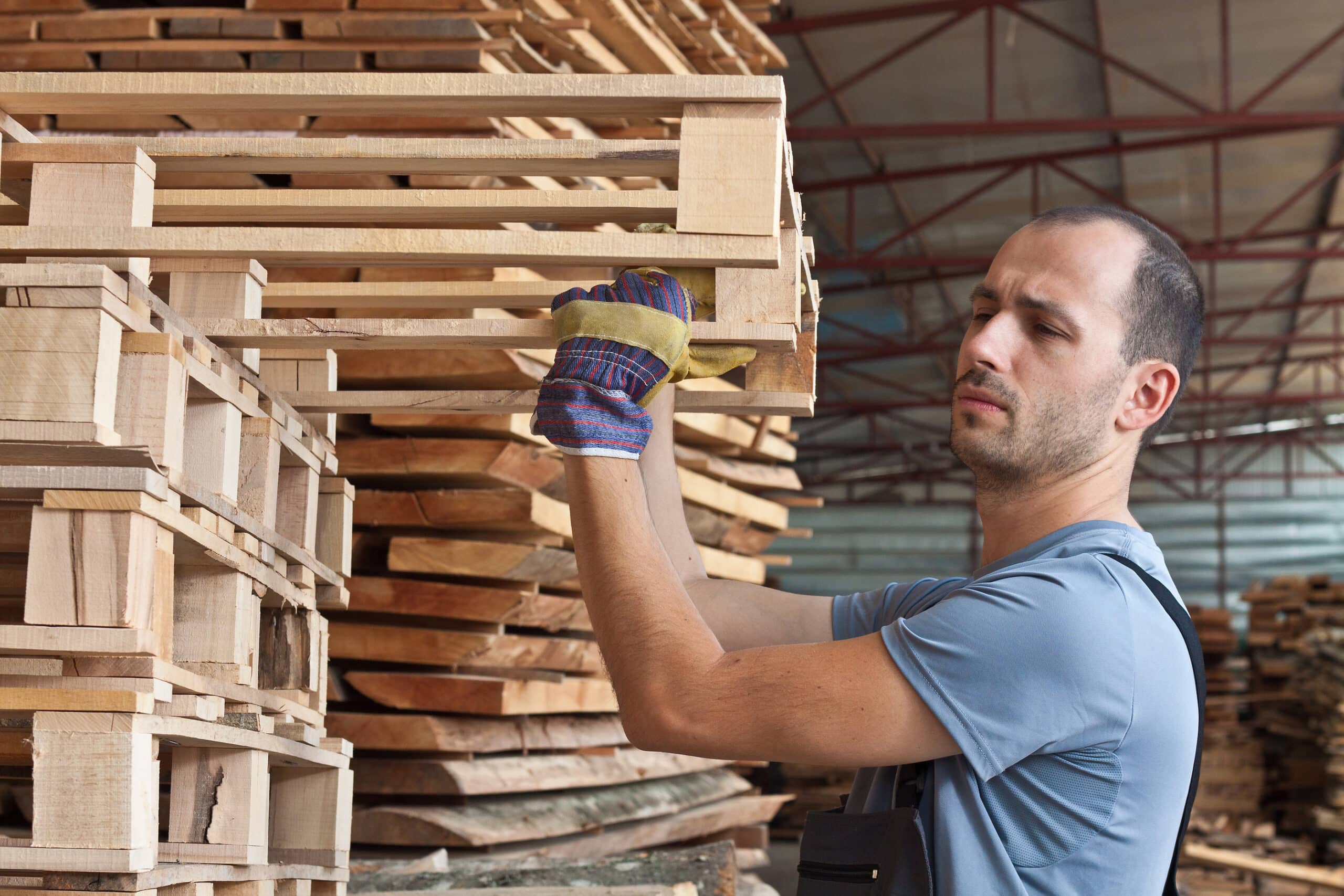 Man Arranging Pallets, Horizontal Shot