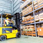 Forklift lifting pallets of inventory in an Indianapolis, IN warehouse